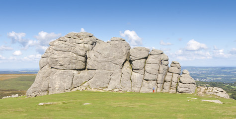 Climbers scale Haytor Rock on Dartmoor - Devon, England.