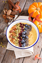 Pumpkin smoothie bowl with chia seeds, pecans, cranberries