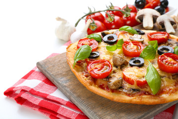 Tasty pizza with vegetables and basil close up