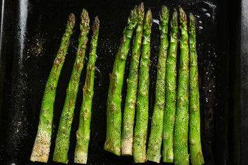 Roasted asparagus on pan, close-up