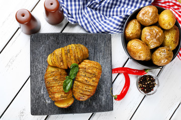 Baked potatoes on wooden table, top view