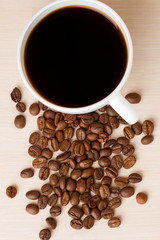Coffee Cup and coffee beans on wooden table