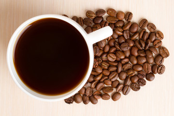 Coffee Cup and coffee beans on wooden table