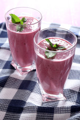 Delicious berry smoothie with blackberries on table close up
