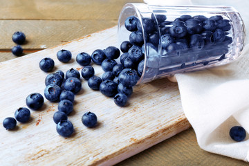 Fresh blueberries in glass on wooden table close up