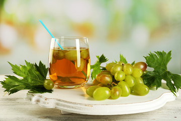 Grape and glass with juice on the table