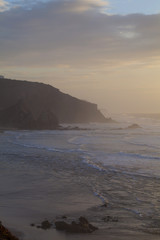 Fototapeta na wymiar Sunset in wild Atlantic Ocean coast in Portugal.