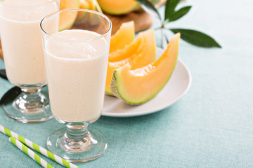 Healthy cantaloupe smoothie in a tall glass