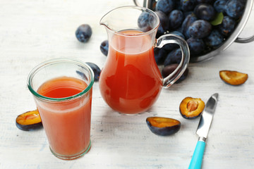 Plum Juice in jar and glass with fresh fruits