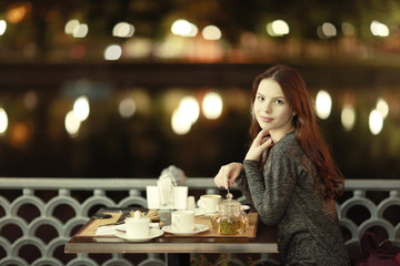 girl, night, dinner at an outdoor cafe