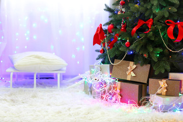 Perfect Christmas tree with gifts underneath in living room