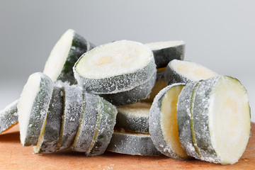 Frozen zucchini on the board for cutting