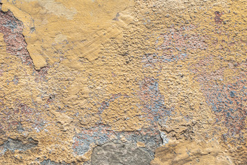 old chipped plaster on the concrete wall texture background