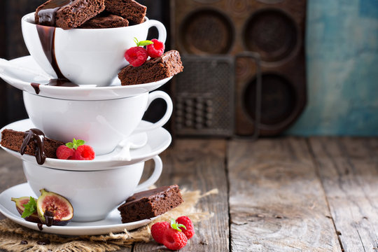 Brownies In Stacked Coffee Cups With Chocolate Sauce