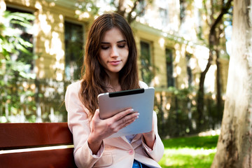 Fototapeta premium young caucasian female student with tablet on campus