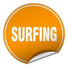 surfing round orange sticker isolated on white