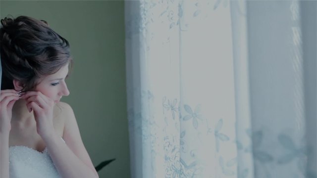 The bride wears a wedding accessory