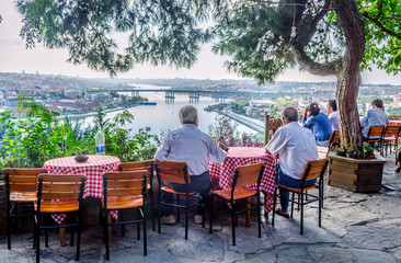 People are sitting pierre loti restaurant situated in the middle of graveyard in Istanbul.