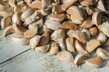 The cloves of garlic on old wooden surface