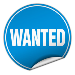 wanted round blue sticker isolated on white