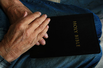 Old Man's Hands on the Holy Bible