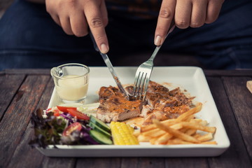 Fat Man Eating pork steak In a coffee shop