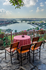 People are sitting pierre loti restaurant situated in the middle of graveyard in Istanbul.