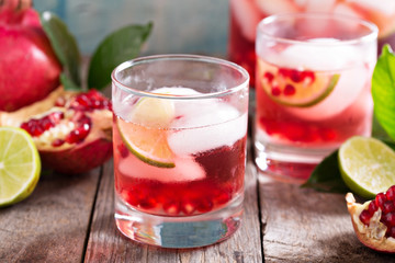 Pomegranate cocktail with lime slices