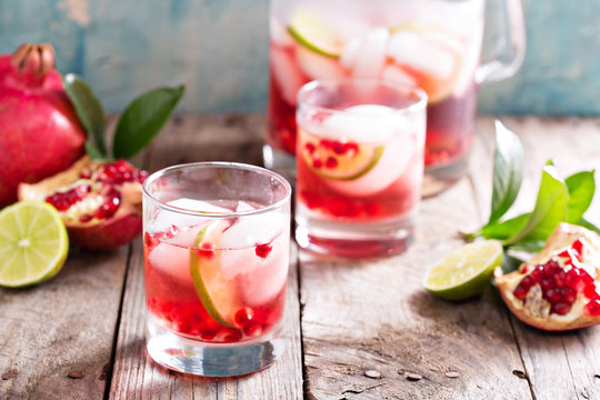 Pomegranate cocktail with lime slices