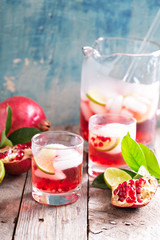 Pomegranate cocktail with lime slices