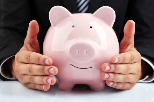 Man with piggy-bank on white background