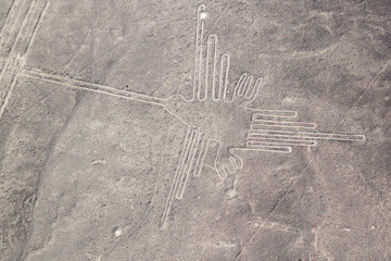 Aerial view of geoglyphs near Nazca - famous Nazca Lines, Peru. In the center, Hummingbird figure...