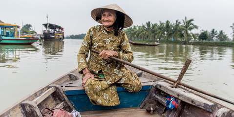 Old friendly woman with vietnamese straw hat
