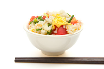 chinese cuisine - homemade fried rice with tomatoes and egg with chop sticks on white with clipping path