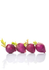 Small purple radish vegetable over white background