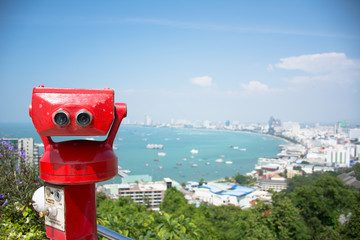 Coin-operated binoculars with pattaya beach in background