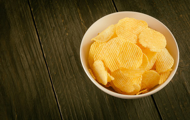 potato chips on wood - soft focus with vintage film filter