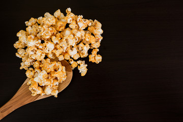 popcorn and ladle scoop on wooden table.