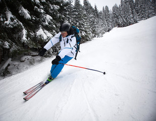 Man skiing on slope - winter holidays