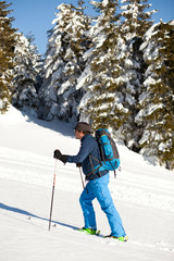 Cross-country skier - snowy mountains in the background