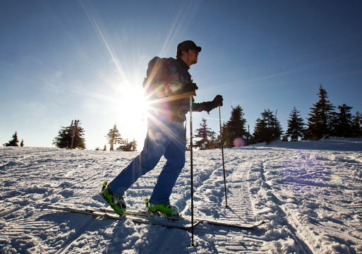 Cross-country skier - snowy mountains in the background