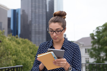 Young professional woman in the city in the city, hands full