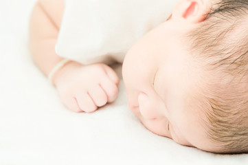 Peaceful baby lying on a bed while sleeping.