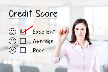 Hand putting check mark with red marker on excellent credit score evaluation form. Office...