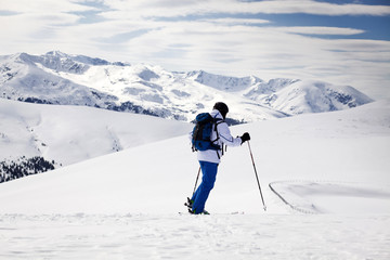 Cross-country skier - snowy mountains in the background