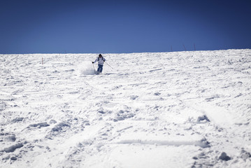 Fototapeta na wymiar Man skiing on slope - winter holidays