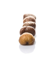 Roasted whole peeled chestnut over white background