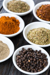Spices and herbs in  bowls.