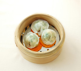 Lee dumpling. yumcha. dim sum in bamboo steamer with chinese bun, pao, bao zi, steamed dumpling, shumai on table in chinese restaurant. chinese cuisine.
