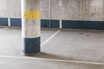 Empty underground parking interior, round column